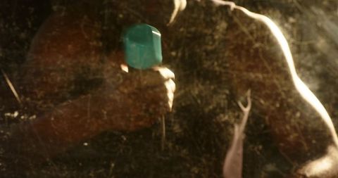 Mid adult african american man gripping teal dumbbell through scratched mirror, workout focus
