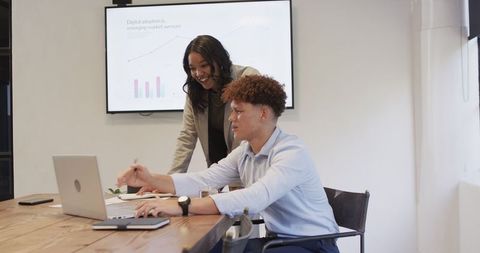 Diverse professionals collaborating on digital trends in office setting