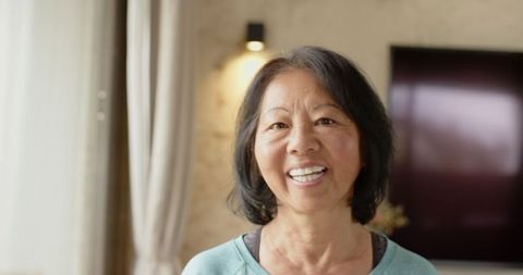 Senior Chinese Woman Smiling in Modern Cozy Interior