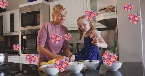 Mother and Daughter Cooking with Floral Heart Elements
