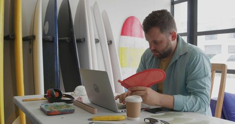 Man balancing work and surfing finds inspiration in coastal office