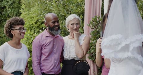 Joyful Wedding Ceremony with Smiling Couple Exchanging Vows Outdoors