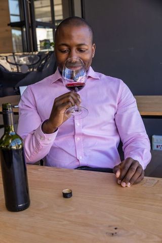 Man enjoying wine tasting in modern wine bar