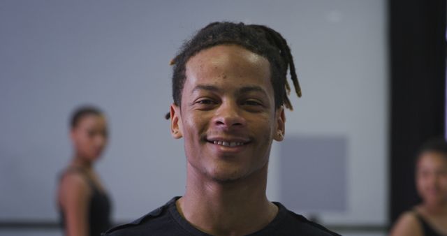 Portrait of happy biracial male dancer with dreadlocks at dance class, copy space. Dancer, contemporary dance, modern ballet, movement and training, unaltered.