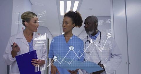 Medical team collaborating with holographic data analytics in hospital corridor