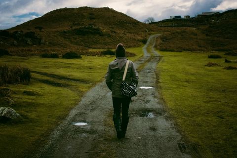Person Walking on Rural Path in Winter Clothing