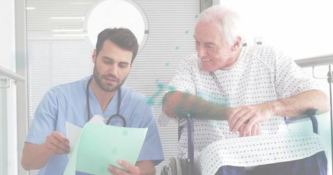 Male nurse reviewing medical records with senior wheelchair patient during consultation