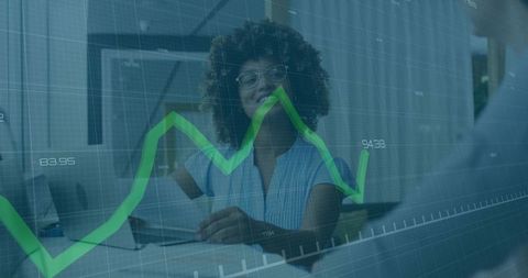 Smiling Businesswoman Analyzing Financial Graphs in Modern Office