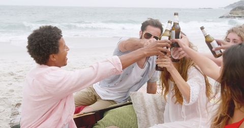 Diverse Friends Celebrating and Toasting on Beach