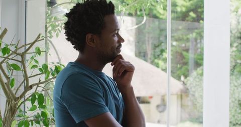 Thoughtful Person Gazing Out Home Window Transform Front View