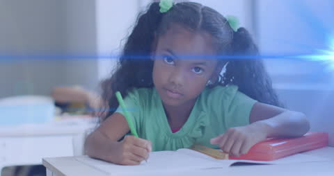 Thoughtful Schoolgirl Writing in Classroom with Light Effects
