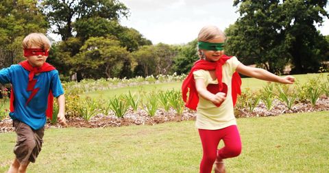 Children Dressed as Superheroes Running in Park