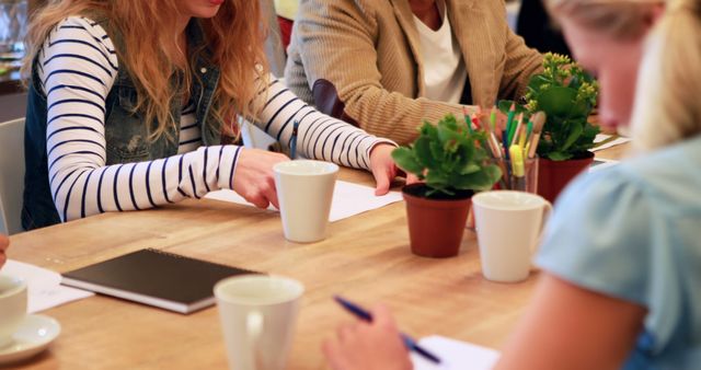 Team Meeting with Potted Plants on Table - Download Free Stock Images Pikwizard.com