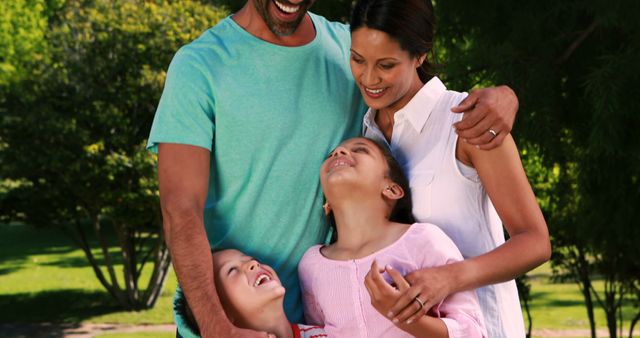 Diverse Family Laughing Together Outdoors on Sunny Day - Download Free Stock Images Pikwizard.com