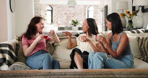 Diverse Friends Celebrating Engagement Over Tea at Home