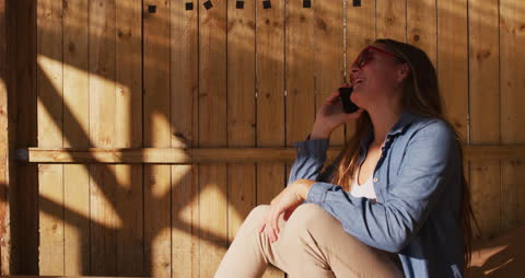 Female Skateboarder Relaxing and Taking a Phone Call