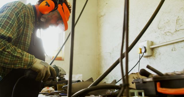 Male Craftsman Using Angle Grinder in Workshop Desaturated Colors - Download Free Stock Images Pikwizard.com