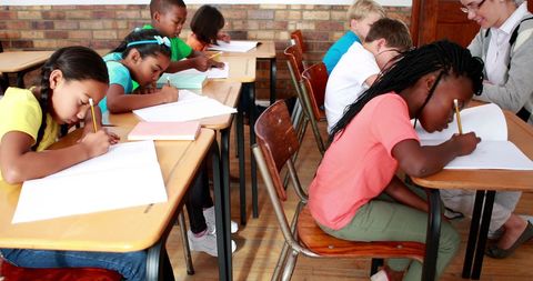 Children Focusing on Schoolwork in Diverse Classroom Setting