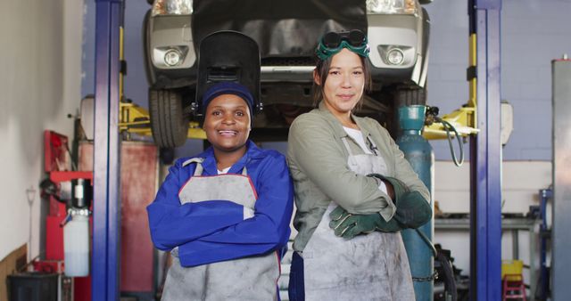 Confident Female Auto Mechanics Posing in Repair Garage - Download Free Stock Images Pikwizard.com