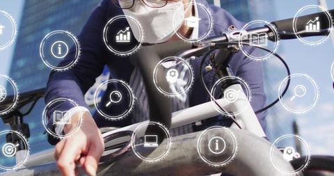 Mature businessman wearing mask leaning over bicycle unlocking with ar data icons