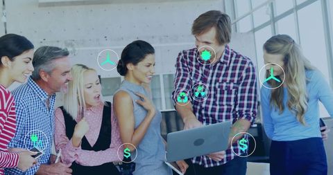 Team collaborating on laptop with green energy icons and sustainable finance overlay