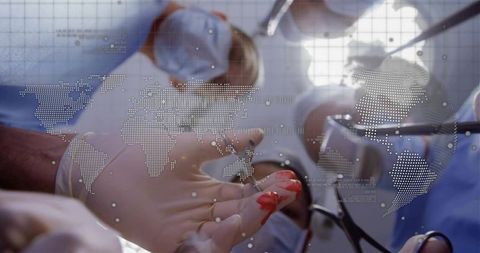 Surgical team performing operation holding bloody gloved hand with world map overlay