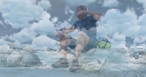 Middle-Aged Hiker Resting by Rocky Coast with Dramatic Blue Skies