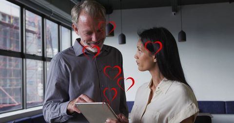 Diverse Colleagues Discussing Work with Heart Icons Overlay