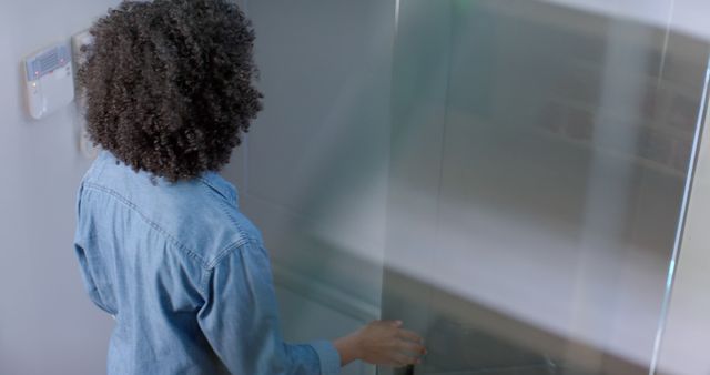 Back View Of Person With Curly Hair Exiting Modern Room - Download Free Stock Images Pikwizard.com