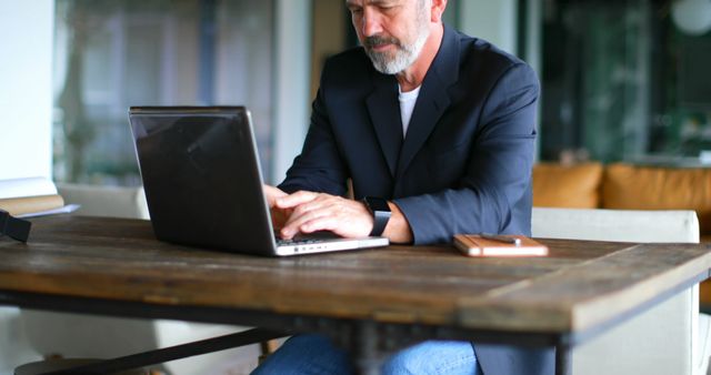 Senior Professional Working on Laptop at Office Desk - Download Free Stock Images Pikwizard.com