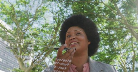 Innovative professional woman connecting with digital technology outdoors