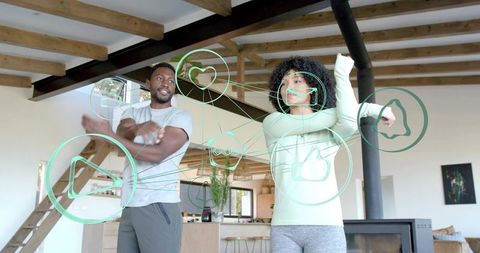 Couple stretching in modern open-plan home with ar fitness icons and social engagement