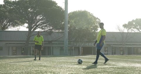 Soccer Players Practicing on Sunny Field, Preparing for Match