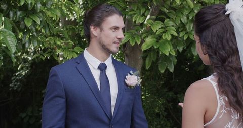 Groom in Blue Suit Exchanging Vows at Outdoor Wedding