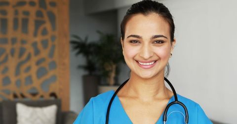 Smiling female doctor with stethoscope in hospital setting