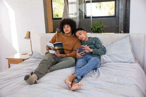 Couple Relaxing at Home Together in Contemporary Bedroom