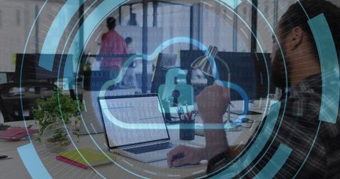 Working Man Typing on Laptop with Cloud Security HUD Overlay in Modern Open Office