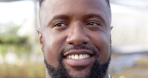 Smiling African American Man in Garden on Sunny Day