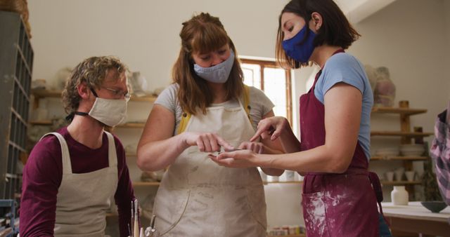 Ceramic Art Students Learning Clay Shaping Techniques with Instructor - Download Free Stock Images Pikwizard.com