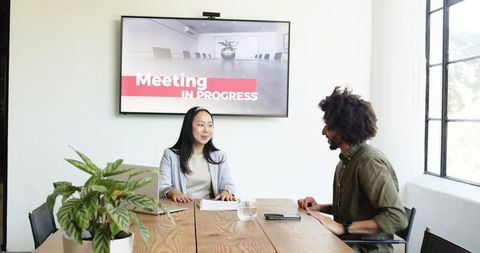 Diverse Professionals Discussing in Modern Office Meeting
