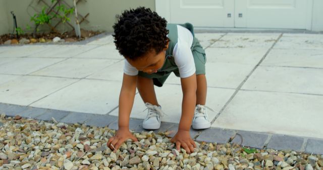 Curious Child Exploring Pebbles Outdoors in Summer - Download Free Stock Images Pikwizard.com