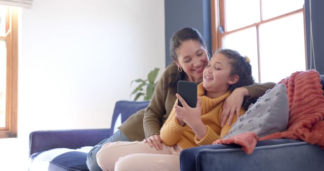 Mother and Daughter Relaxing at Home on Couch Using Smartphone - Download Free Stock Images Pikwizard.com