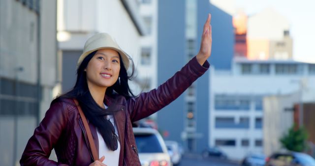 Smiling Woman Hailing Taxi on City Street on a Sunny Day - Download Free Stock Images Pikwizard.com