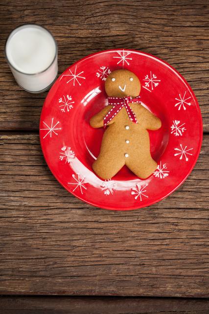 Ginger bread and milk on wooden table during christmas time