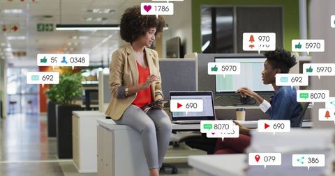 Diverse Coworkers Collaborating with Social Media Notifications in Office