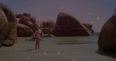 Child Explorers in Rocky Coastal Cove Sparkling Lights