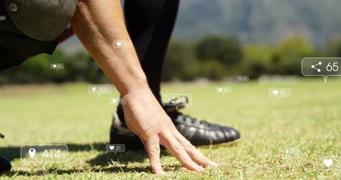 Athlete placing hand on turf at sprint start with cleat and social media overlays