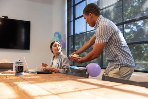 Diverse Coworkers Celebrating with Cake and Coffee in Office