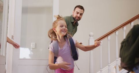 Joyful moment as a father and daughter arrive home, showcasing joy and bonding. Great for family lifestyle themes, depicting tradition, togetherness, and domestic life in home settings.