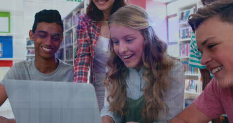 Students Engaged with Laptop in Modern Library Setting